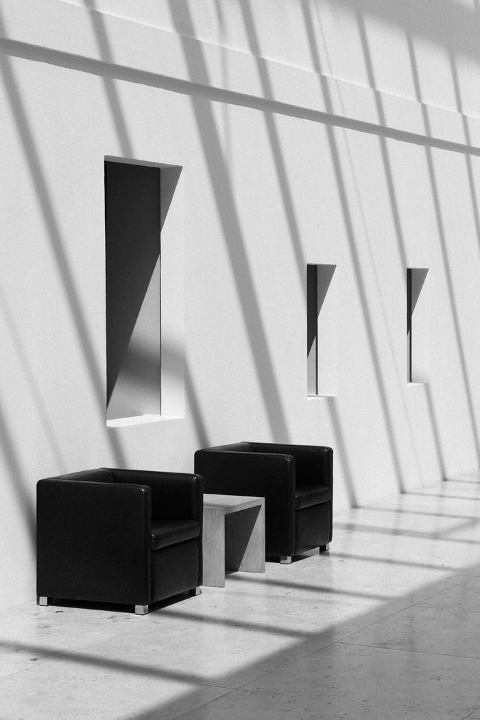 Crafting Captivating Headlines: Your awesome post title goes here Elegant black and white interior featuring shadows and minimalist design furniture.